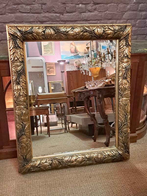 Art Nouveau period curved mirror in stucco gilded with gold leaf
