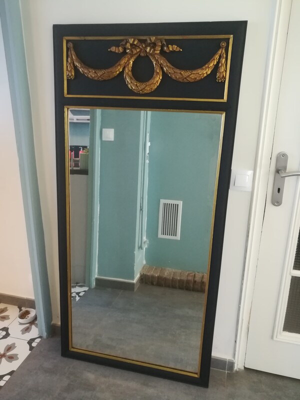 Black painted and gilt stucco Louis XVI style beveled mirror