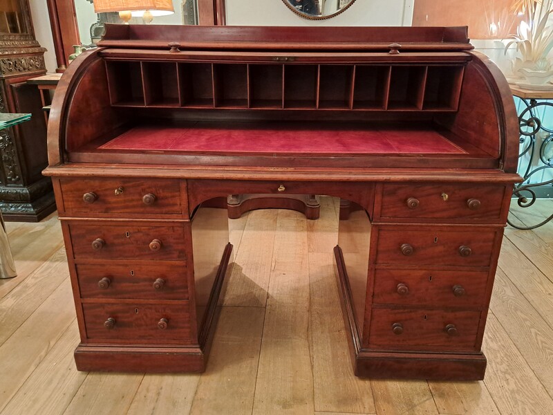 Curtained roll top desk in flamed mahogany and leather