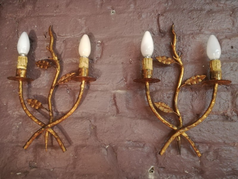 Pair of golden metal wall lights with foliage pattern