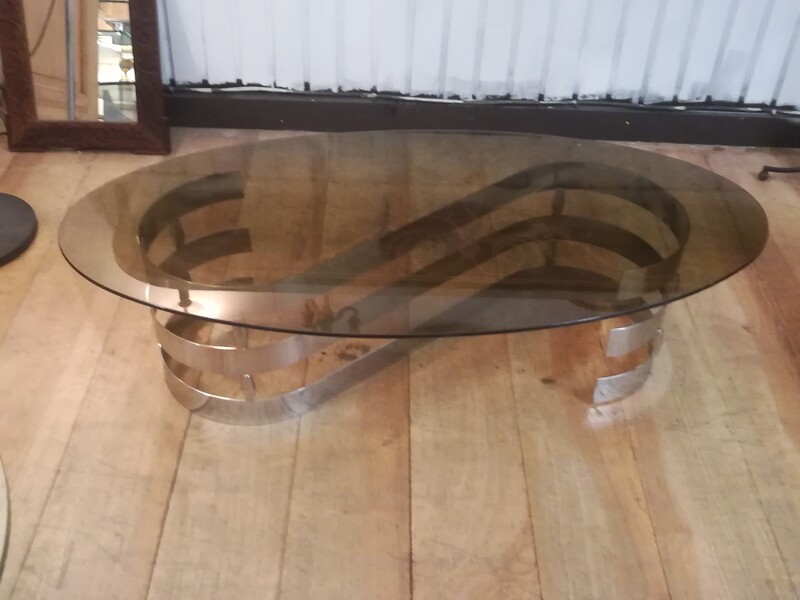 Smocked oval glass top and chromed metal coffee table