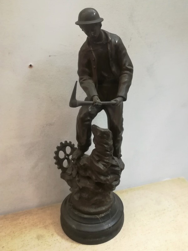 Spelter and wooden base working miner