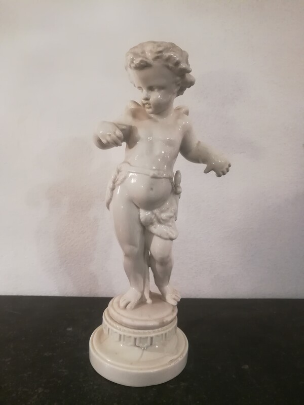 White porcelain cherub statue